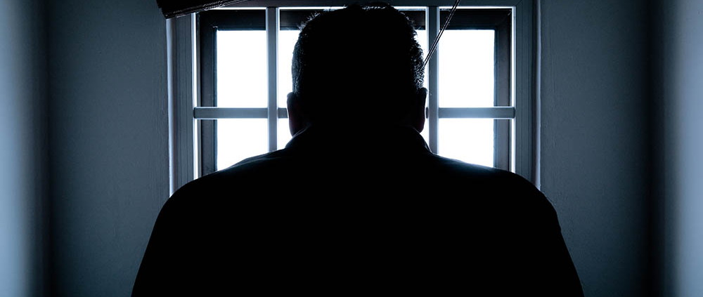 silhouette of a man in window mediano