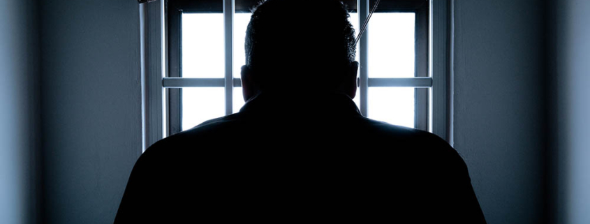 silhouette of a man in window mediano